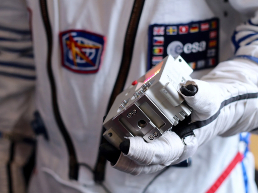 An astronaut holding the Astro Pi.